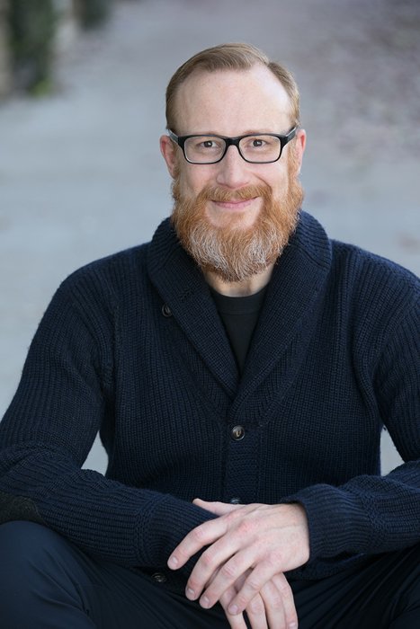 Kevin Ringstaff, founder of PetCloud, smiling in a navy cardigan